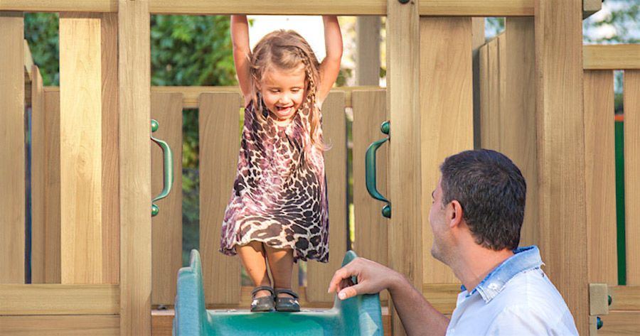 Jung Child happy sliding from a plastic slide